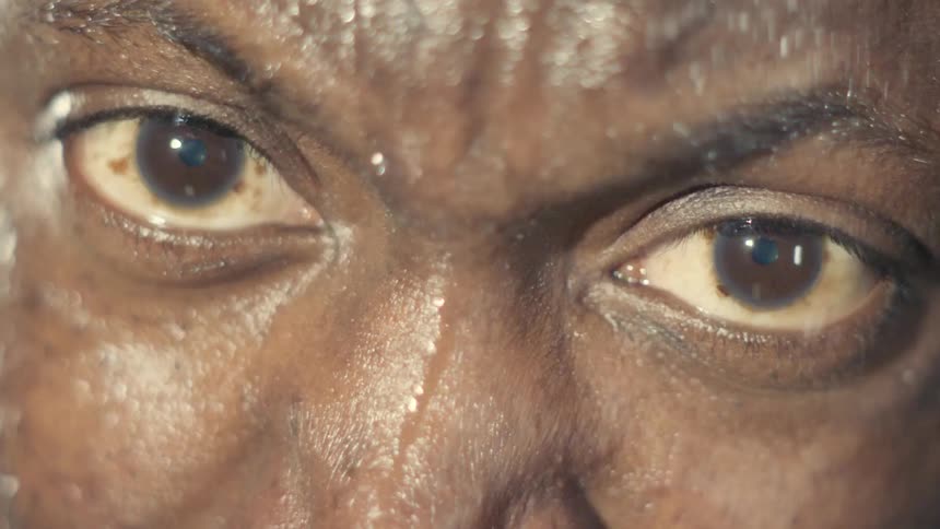 Sweating man stares intently