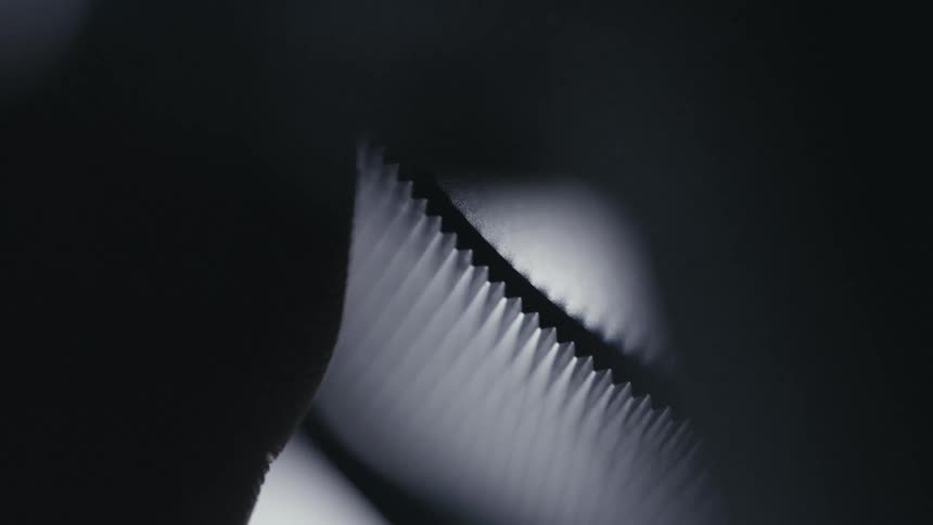 Person turns notched dial