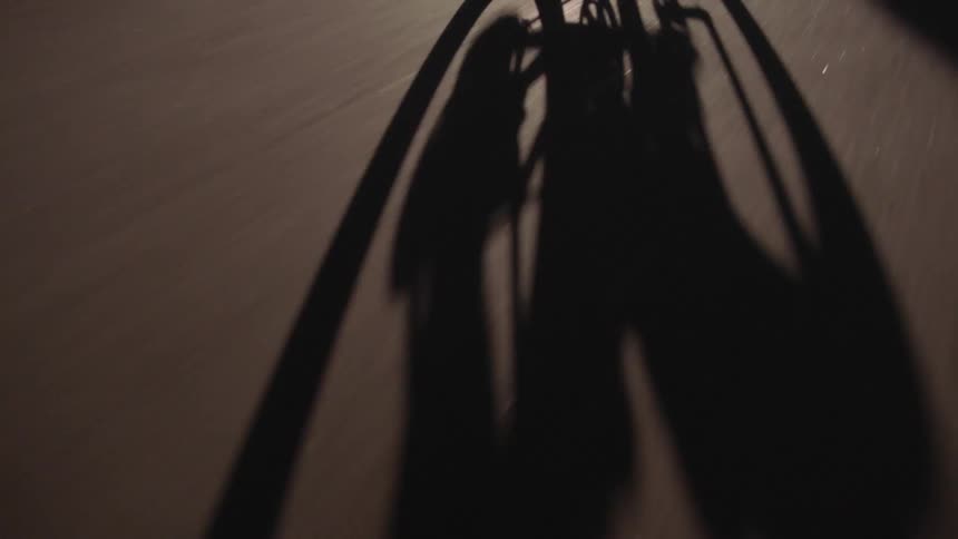 Close up shadow of a cyclist riding on a road