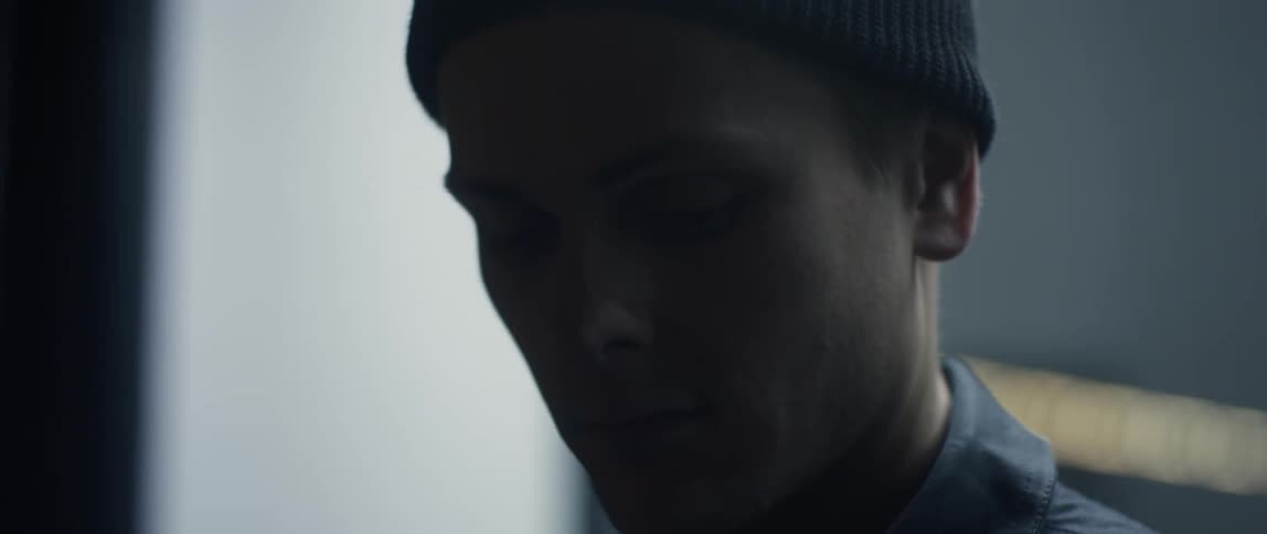 A man looks up in the dark room