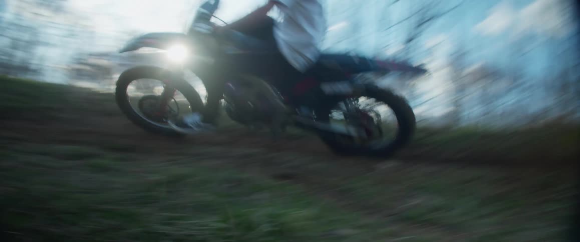 Man rides motorcycle in circle in field