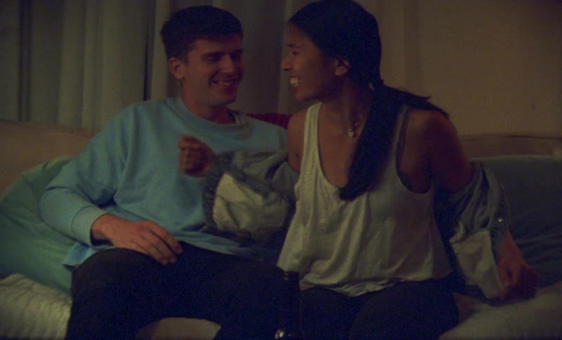 A couple make out on the couch
