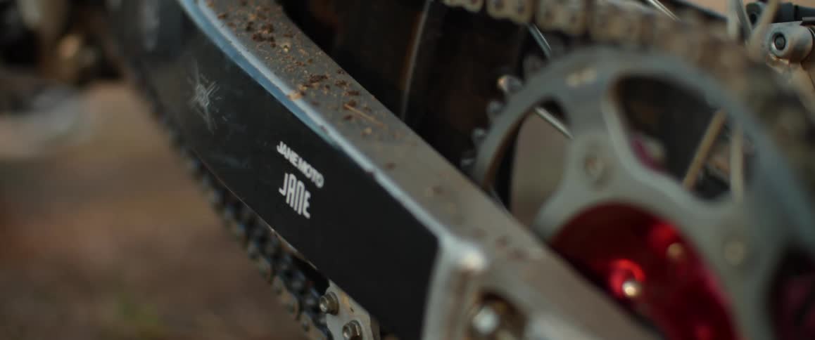 Close up of the dirty chain and sprocket of a motorcycle