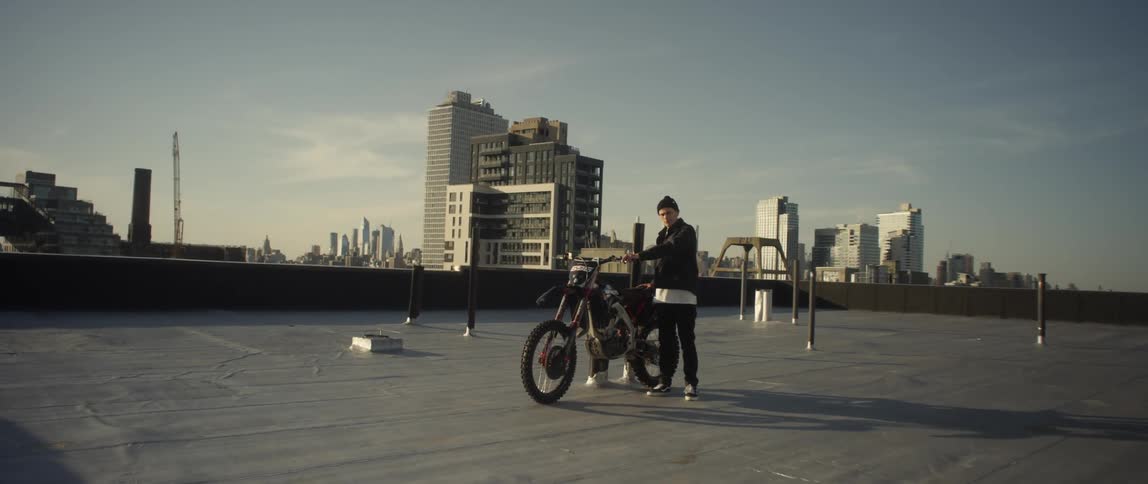 A man standing next to a motorcycle outdoors