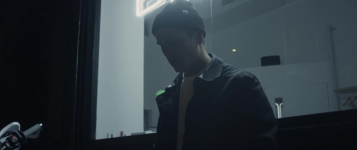 A man adjusts his jacket at night