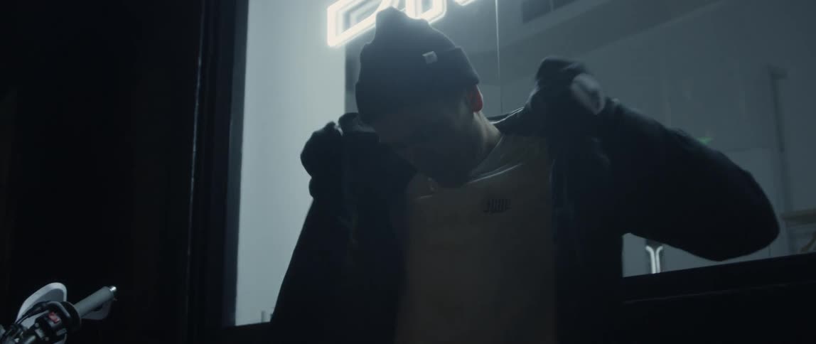 A man puts on his jacket