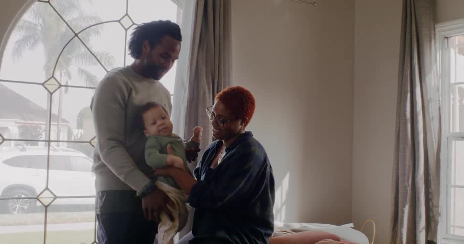 Parents hold their son and talk to him