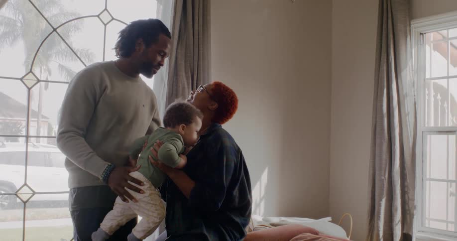 A family standing around in a room