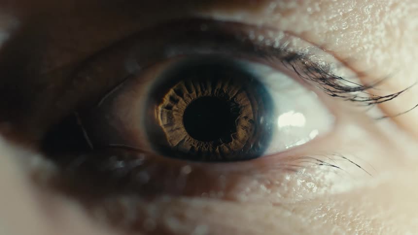 Close up of woman opening brown eye