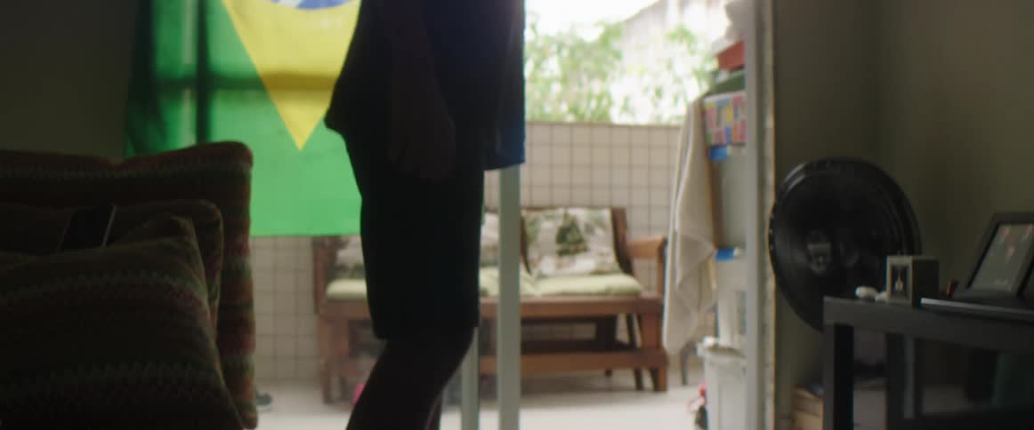 A boy is playing soccer inside of his house