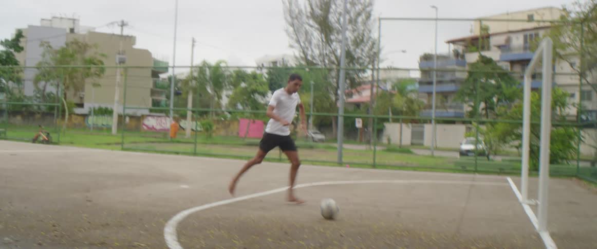 Two people are playing soccer at a public park in spring
