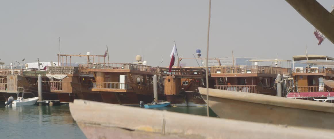 Flags on house boats bobbing at dock flap in the wind