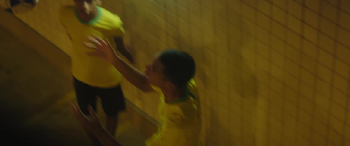 Three boys tossing a soccer ball back and forth