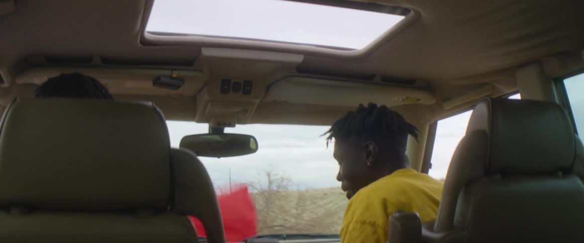Man talks to driver as they pass through countryside