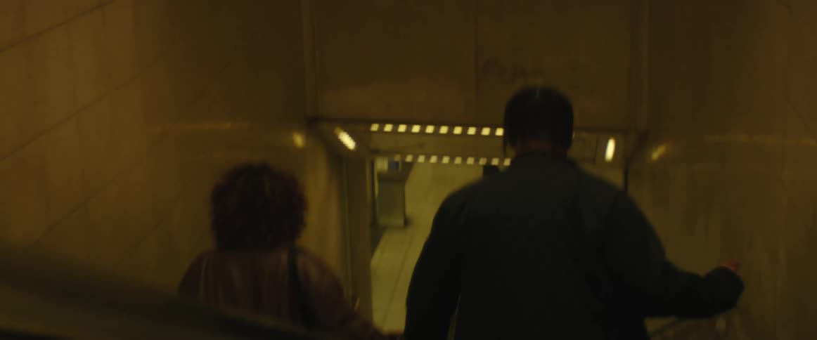 Man and woman are walking down a flight of stairs together