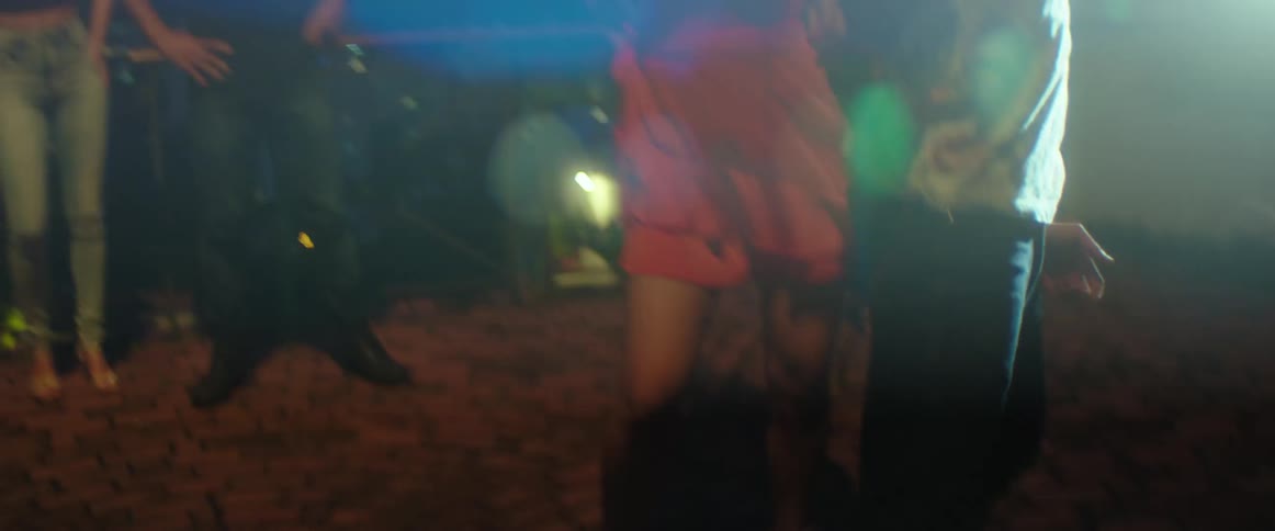 People are dancing outside with flashing lights