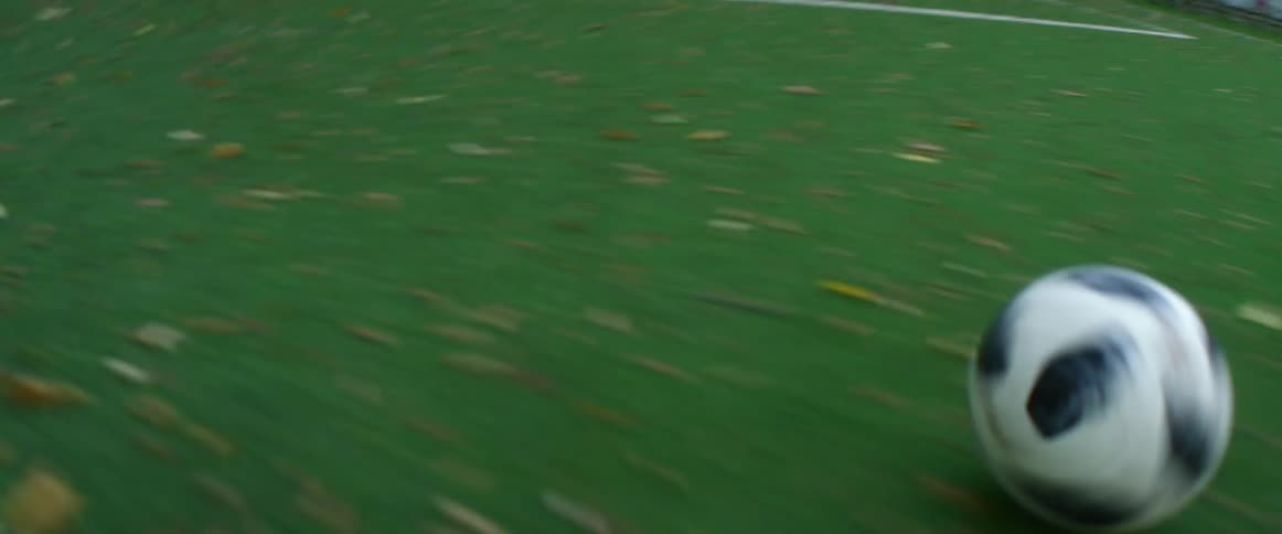 Soccer ball being kicked on a soccer field until it reaches the goal