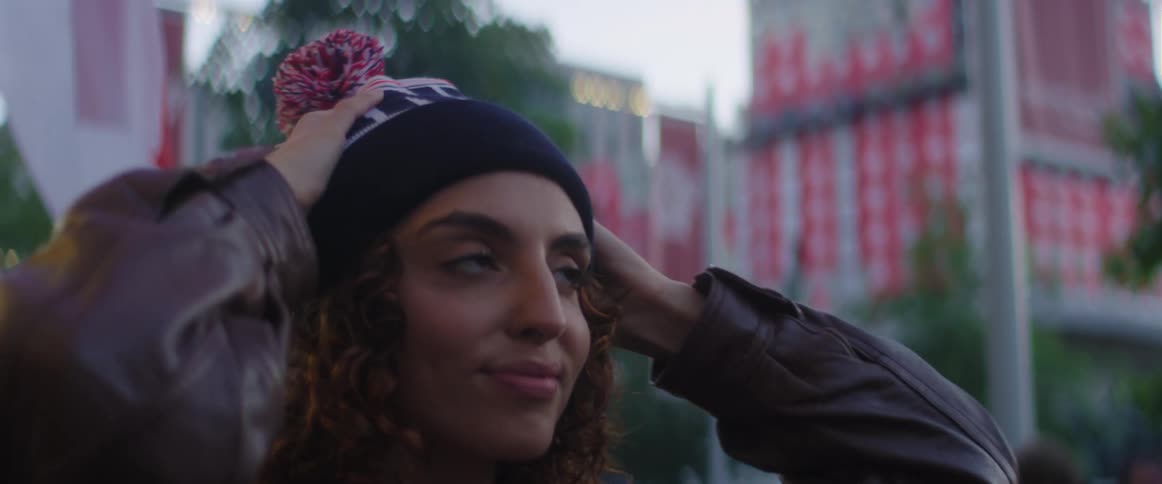 Female putting on hat
