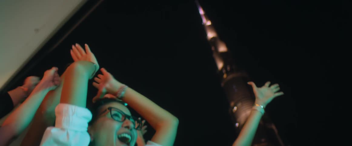 A group of people are cheering and celebrating together
