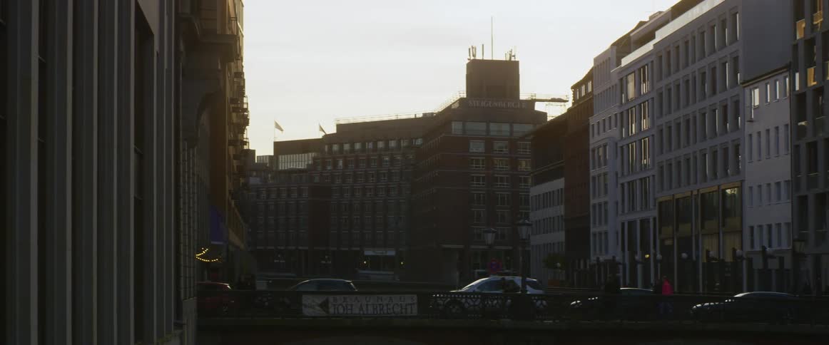 Pedestrians walking over a bridge in the city at morning