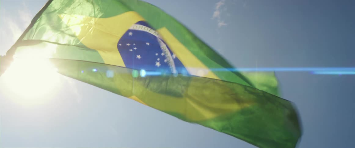 Flag of brazil fluttering in wind against the sky