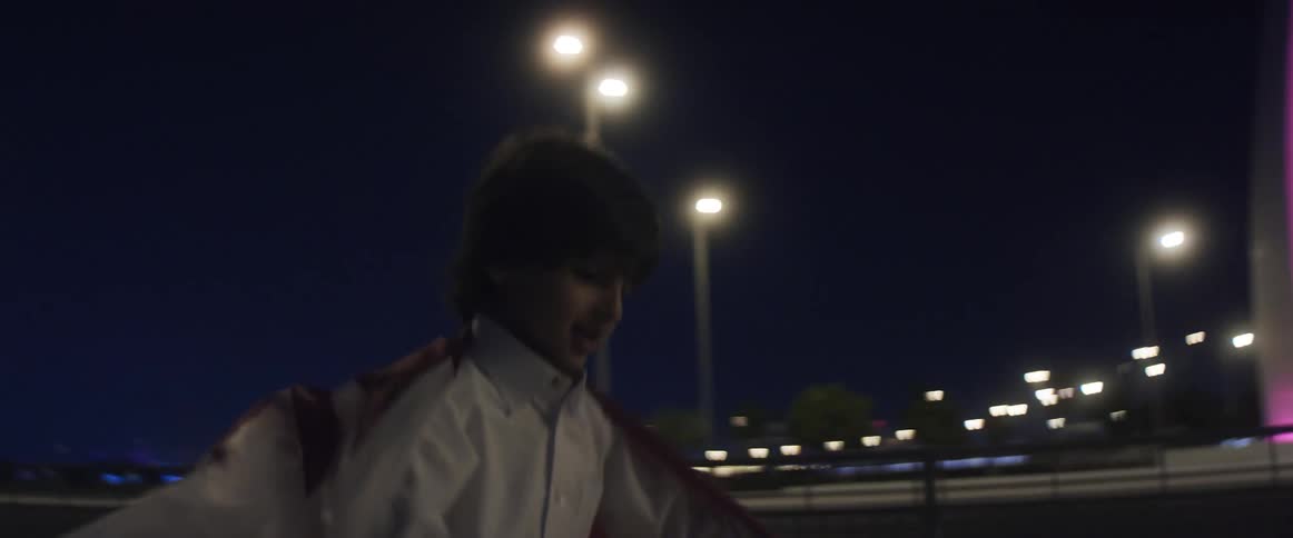A child is celebrating and carrying a flag around at night