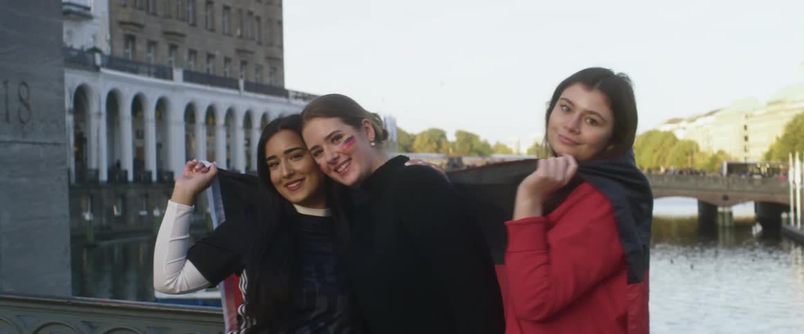 A group of three women standing outdoors