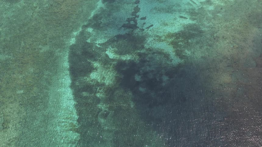 Birds eye view of ocean water is displayed
