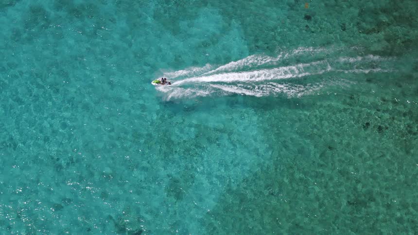 People are jet skiing across a body of water