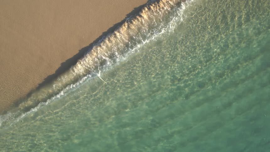 Aerial view of an ocean coast is displayed