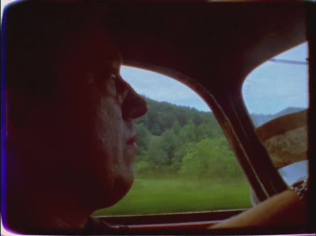 Close-up of a man driving on a cloudy day