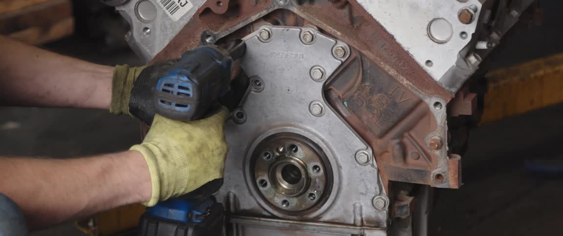 Mechanic disassembles car engine at the garage