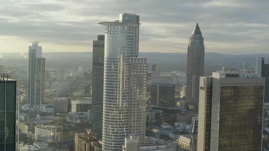 Aerial view of an urban city at dusk is displayed