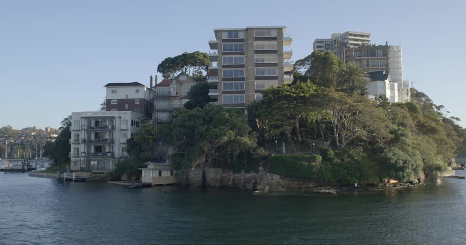 City buildings near the coast of a body of water is displayed