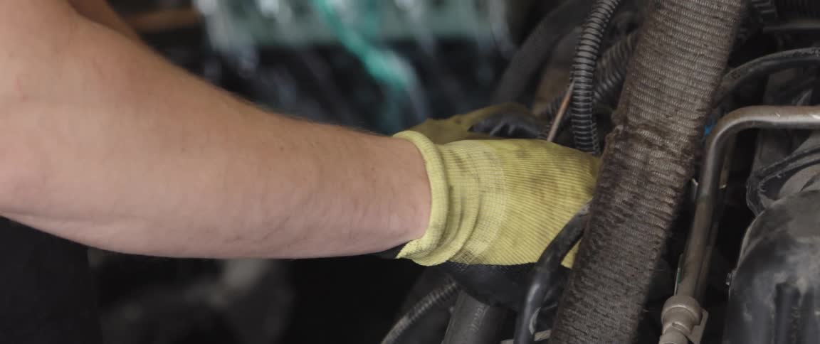 A person working on an engine in a car