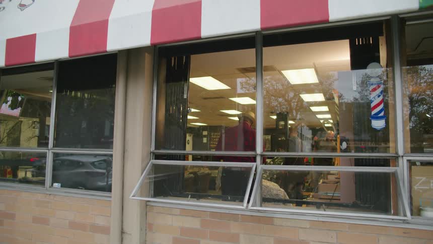A view through a window into a barber shop