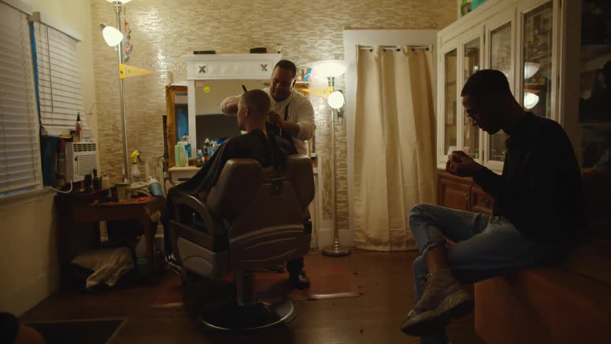 A man cutting a persons hair