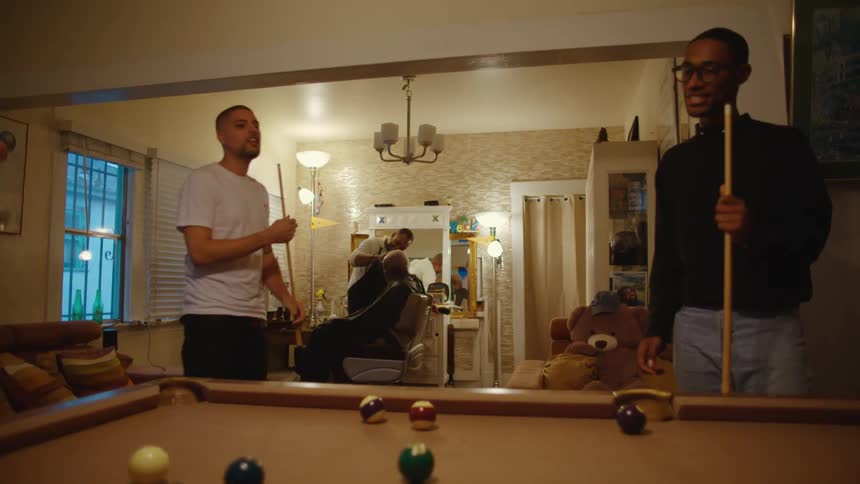 Two men are playing a game of pool indoors