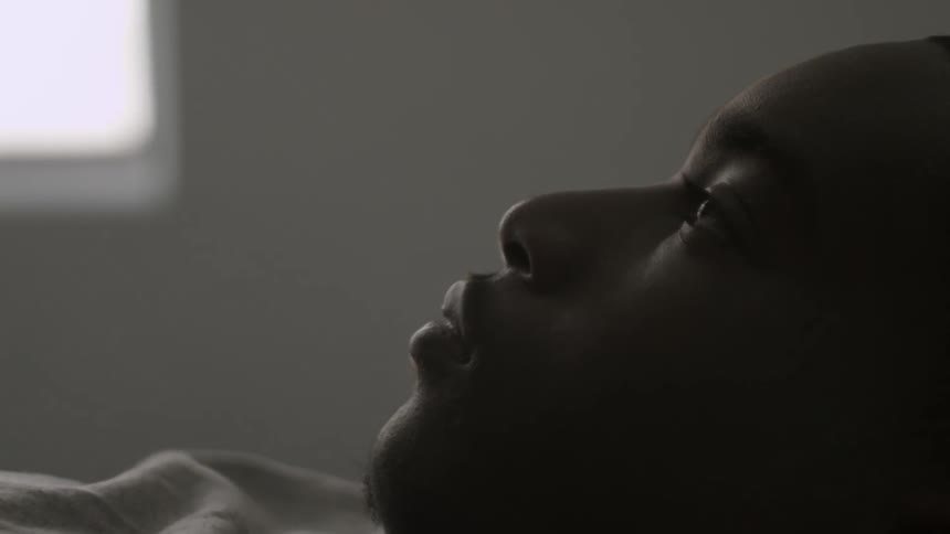 A man is laying down looking up