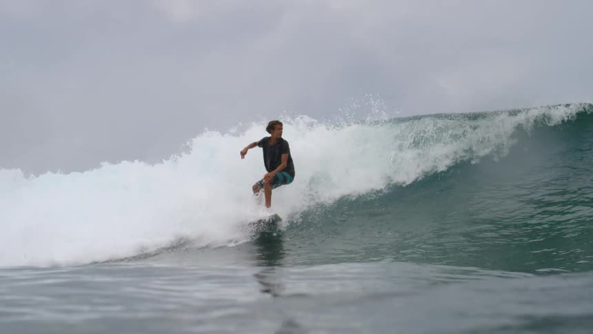 A wave knocks a surfer underwater