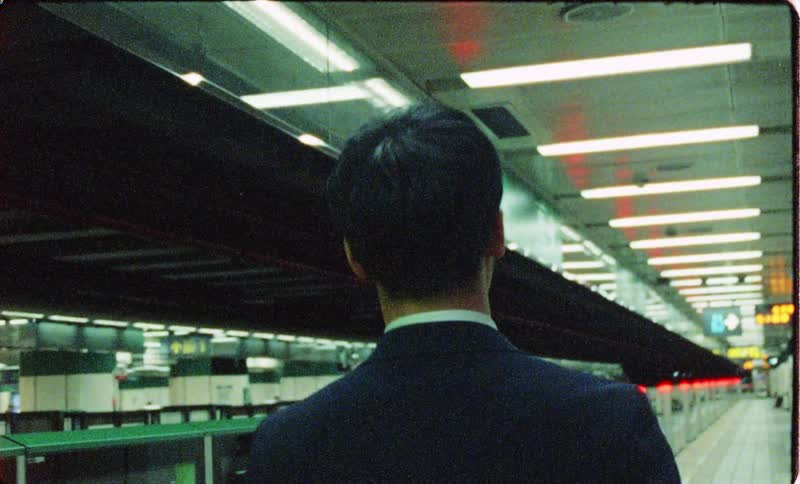 Man in suit walks in subway station