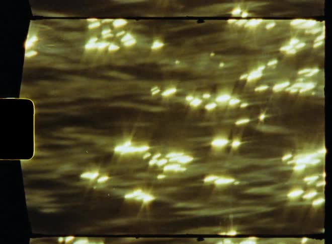 Video footage of sunlight on a lake is displayed