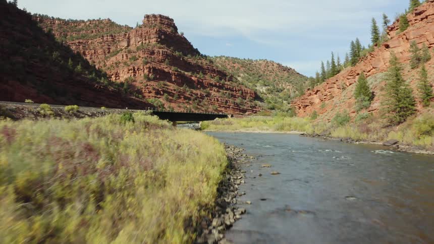 A river is flowing through a mountainous area in spring