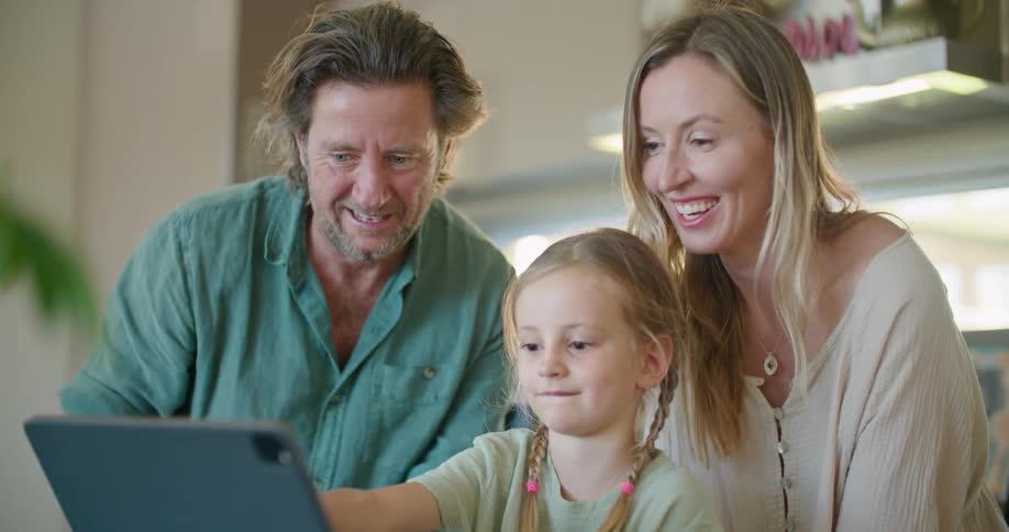 A family are looking at a tablet together