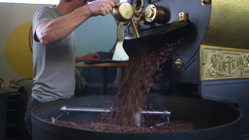 Person using coffee bean mixer