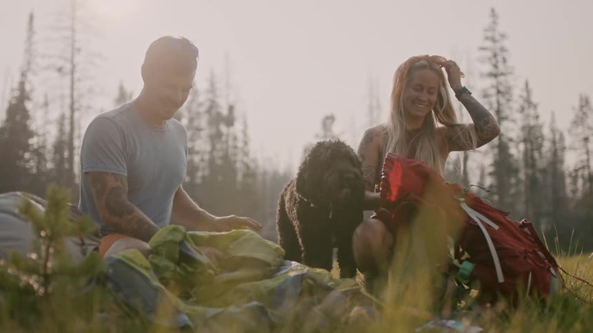 A view of a man and woman sitting outside camping