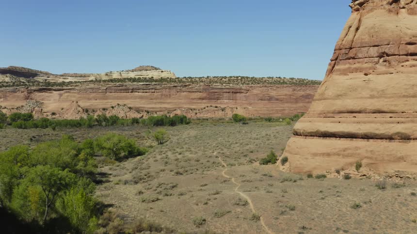 Desert badlands and mesa under a clear sky