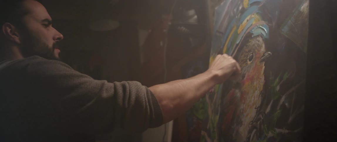 A man paints a picture of a bird