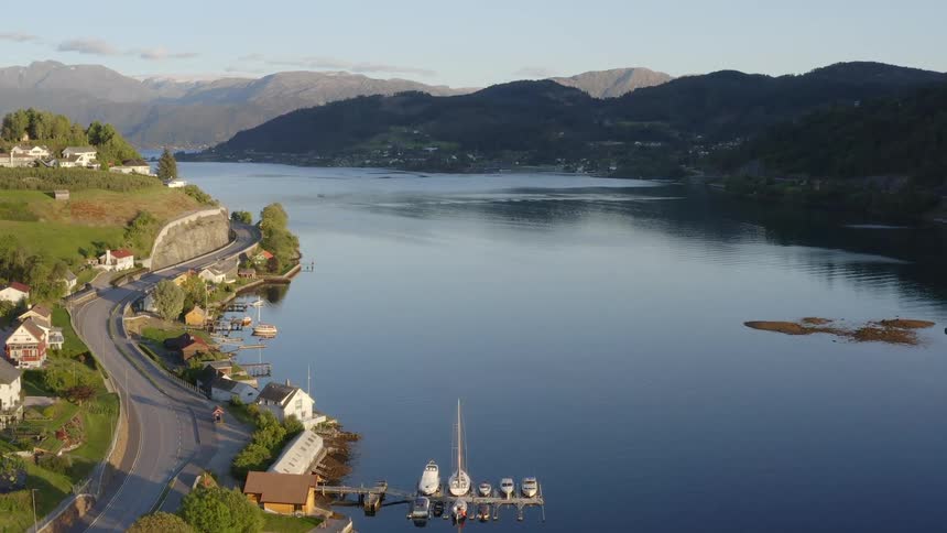 Aerial view of coastal town with boats and highway