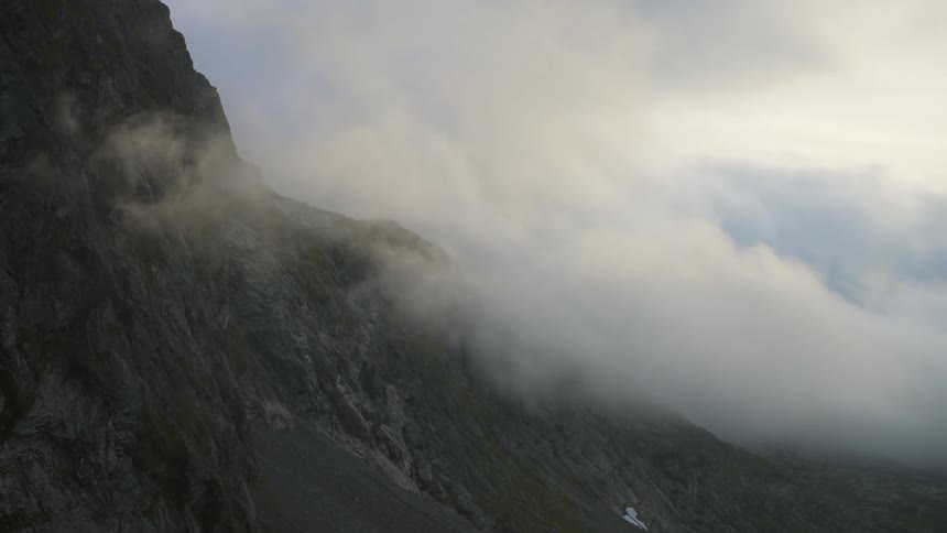Low lying clouds obscure mountain side